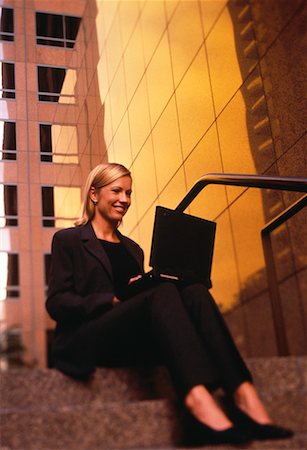 simsearch:700-00083403,k - Businesswoman Sitting on Steps Using Laptop Computer, Smiling Stock Photo - Rights-Managed, Code: 700-00064550