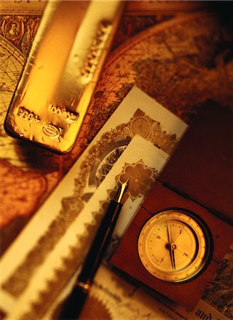 Compass, Pen, Gold Bar and Certificates on Antique World Map Stock Photo - Rights-Managed, Code: 700-00065164