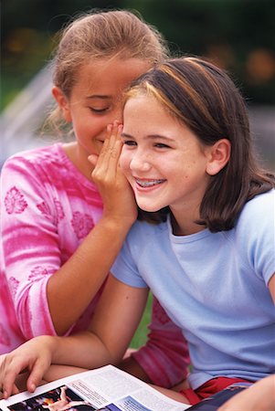 pictures of a little girl whispering - Two Girls Whispering Outdoors Stock Photo - Rights-Managed, Code: 700-00066434