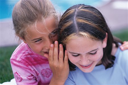 pictures of a little girl whispering - Two Girls Whispering Outdoors Stock Photo - Rights-Managed, Code: 700-00066435