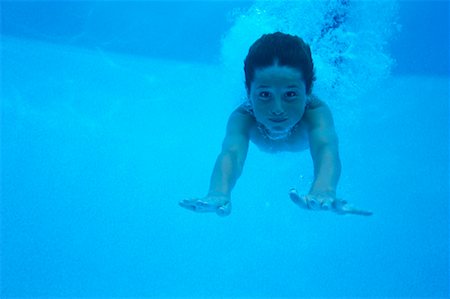 Underwater View of Boy Diving Into Swimming Pool Stock Photo - Rights-Managed, Code: 700-00066830