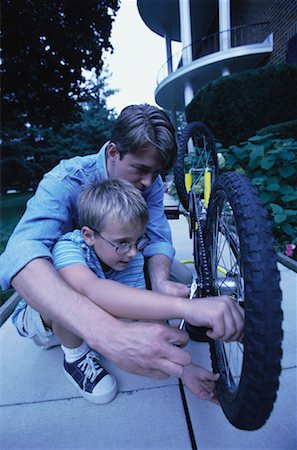 peter griffith - Father and Son Fixing Bicycle Outdoors Stock Photo - Rights-Managed, Code: 700-00067037