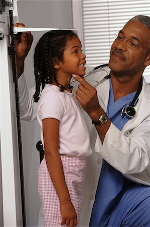 simsearch:700-00616627,k - Mature Male Doctor Measuring Girl's Height in Office Stock Photo - Rights-Managed, Code: 700-00067490