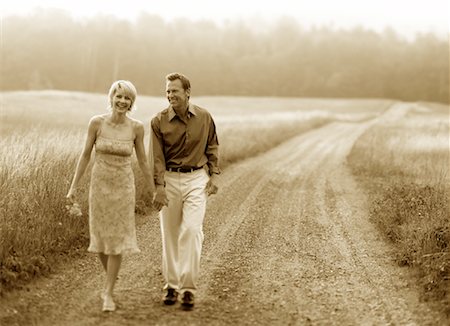 Couple Walking on Dirt Road Holding Hands Stock Photo - Rights-Managed, Code: 700-00068638