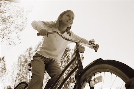 simsearch:700-00088996,k - Looking Up at Girl Riding Bicycle Stock Photo - Rights-Managed, Code: 700-00069302