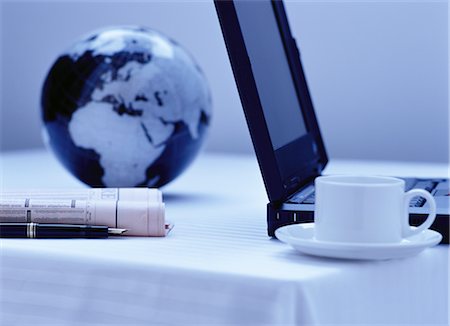 Laptop, Coffee Mug, Globe, Pen And Newspaper Stock Photo - Rights-Managed, Code: 700-00069434