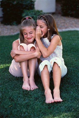 pictures of a little girl whispering - Two Girls Sitting Outdoors Whispering Stock Photo - Rights-Managed, Code: 700-00060171