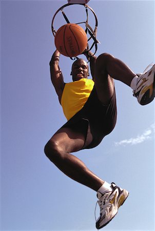 simsearch:700-00060777,k - Looking Up at Man Slam Dunking Basketball Outdoors Stock Photo - Rights-Managed, Code: 700-00060307