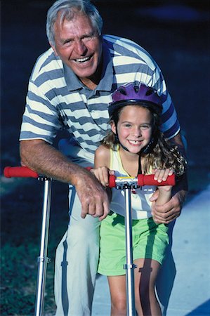 simsearch:700-00046927,k - Grandfather and Granddaughter With Scooters Outdoors Stock Photo - Rights-Managed, Code: 700-00060619