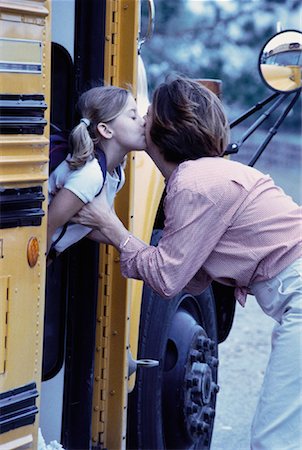 parent child bus - Mother Kissing Daughter Goodbye On School Bus Foto de stock - Con derechos protegidos, Código: 700-00061485