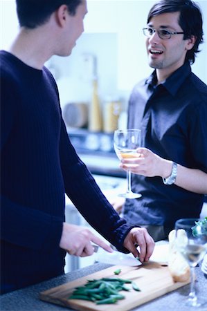 simsearch:6109-08390293,k - Male Couple Preparing Food in Kitchen, Holding Glass of Wine Stock Photo - Rights-Managed, Code: 700-00061781