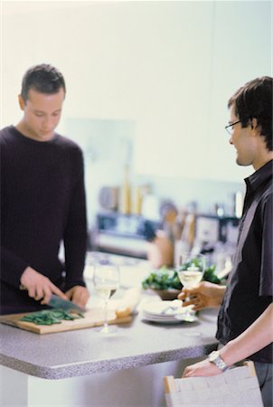 simsearch:6109-08390293,k - Male Couple Preparing Food in Kitchen with Glasses of Wine Stock Photo - Rights-Managed, Code: 700-00061871