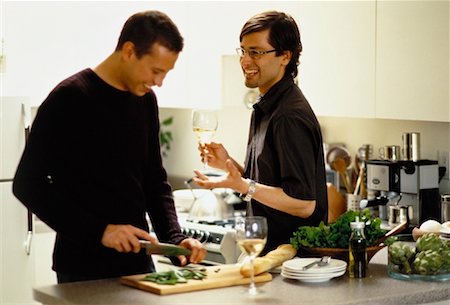 simsearch:6109-08390293,k - Male Couple Preparing Food in Kitchen with Glasses of Wine Stock Photo - Rights-Managed, Code: 700-00061985