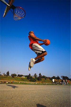 simsearch:700-00060777,k - Man Jumping to Slam Dunk Basketball Outdoors Stock Photo - Rights-Managed, Code: 700-00062411