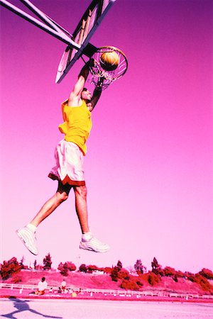 simsearch:700-00060777,k - Man Jumping to Slam Dunk Basketball Stock Photo - Rights-Managed, Code: 700-00062508