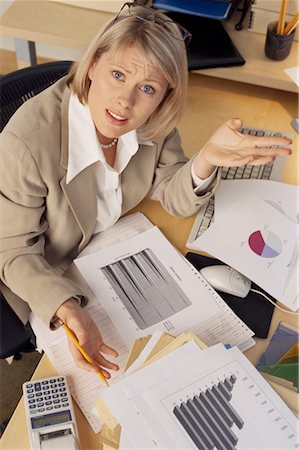 simsearch:700-01248157,k - Portrait of Businesswoman Sitting At Desk with Piles of Paper Stock Photo - Rights-Managed, Code: 700-00074077