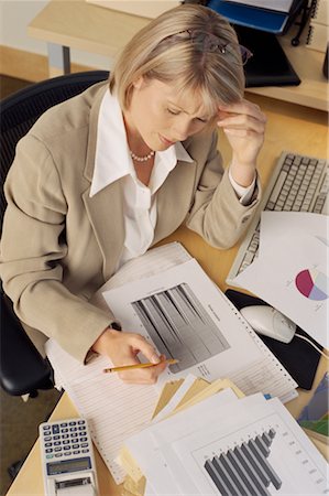 simsearch:700-01248157,k - Businesswoman Sitting at Desk Looking at Graphs Stock Photo - Rights-Managed, Code: 700-00074078