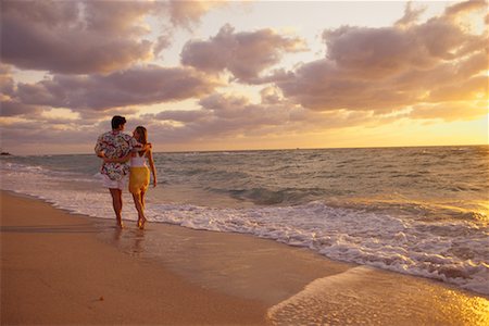 simsearch:700-00021491,k - Vue arrière du Couple marchant en Surf sur la plage au coucher du soleil Photographie de stock - Rights-Managed, Code: 700-00075484