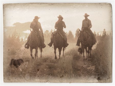 simsearch:700-00161937,k - Cowboys Riding Horses in Field With Dog Stock Photo - Rights-Managed, Code: 700-00075636