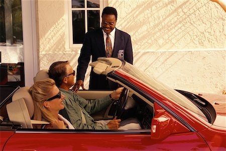 Mature Couple in Convertible Talking to Security Guard Stock Photo - Rights-Managed, Code: 700-00076533