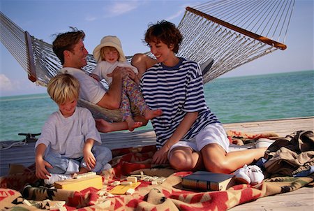 Family Sitting on Deck with Hammock and Dominoes Stock Photo - Rights-Managed, Code: 700-00076857