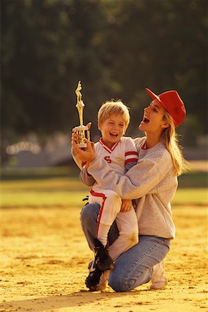 Little League Baseball Player and Coach with Trophy Outdoors Stock Photo - Rights-Managed, Code: 700-00077925