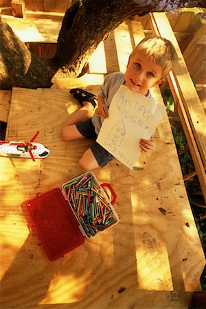 Portrait of Boy Holding Drawing In Tree House Stock Photo - Rights-Managed, Code: 700-00078789