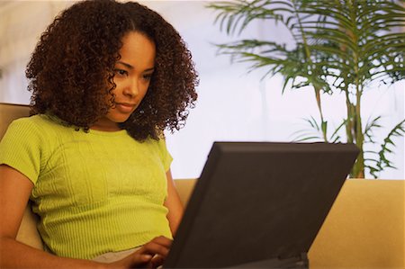 simsearch:700-00083403,k - Woman Sitting on Sofa, Using Laptop Computer Stock Photo - Rights-Managed, Code: 700-00079750