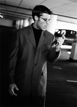 simsearch:700-00163379,k - Businessman Standing in Parking Garage, Holding Cell Phone Scowling Stock Photo - Rights-Managed, Code: 700-00070610