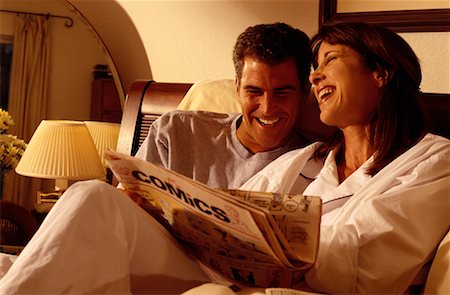 Couple in Pyjamas, Reading Comics Laughing in Bed Stock Photo - Rights-Managed, Code: 700-00071744