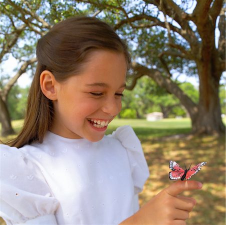 simsearch:700-00085631,k - Girl Wearing Dress with Toy Butterfly on Finger Outdoors Stock Photo - Rights-Managed, Code: 700-00085669