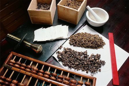 Herbalist's Tools on Table Dried Herbs, Mortar and Pestle Wrapping Paper and Abacus Taiwan Stock Photo - Rights-Managed, Code: 700-00080185