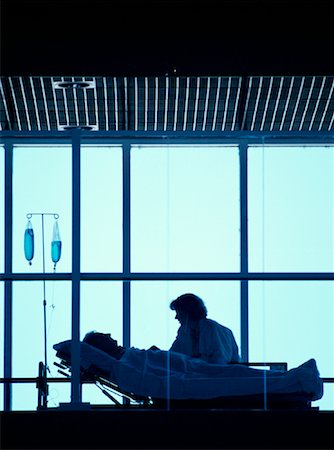 doctor consulting patient in hospital room - Doctor with Patient in Hospital Bed Saskatoon, Saskatchewan, Canada Stock Photo - Rights-Managed, Code: 700-00081278