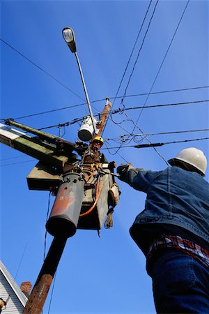 simsearch:700-00049076,k - Looking Up at Men Repairing Power Lines Stock Photo - Rights-Managed, Code: 700-00081556