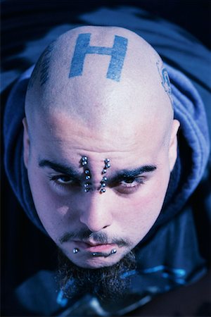 Portrait of Man with Piercings And Tattoos on Head Stock Photo - Rights-Managed, Code: 700-00081867