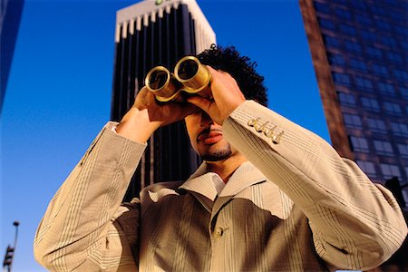 Businessman Using Binoculars by Office Towers Los Angeles, California, USA Stock Photo - Rights-Managed, Code: 700-00082214