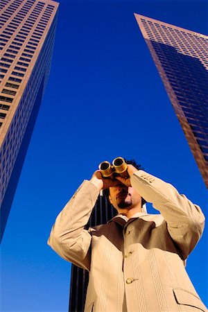 Businessman Using Binoculars by Office Towers Los Angeles, California, USA Stock Photo - Rights-Managed, Code: 700-00082215