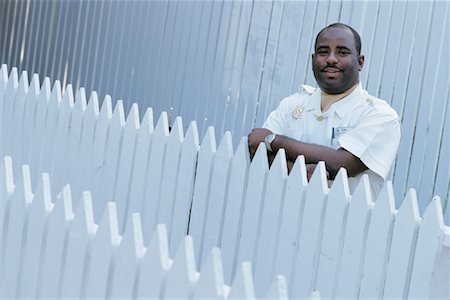 Portrait of Guard Standing Behind Fence at Ocean Club Paradise Island, Bahamas Stock Photo - Rights-Managed, Code: 700-00082675