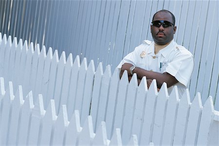 Portrait of Guard Standing Behind Fence at Ocean Club Paradise Island, Bahamas Stock Photo - Rights-Managed, Code: 700-00082676