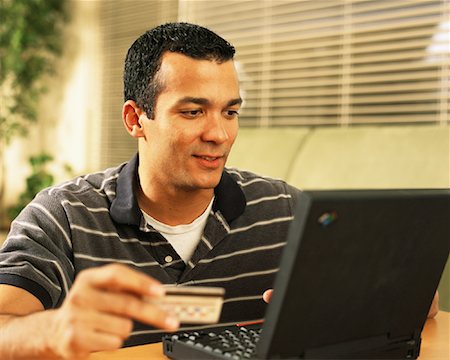simsearch:700-00478040,k - Man Using Laptop Computer and Holding Credit Card at Home Foto de stock - Con derechos protegidos, Código: 700-00083430