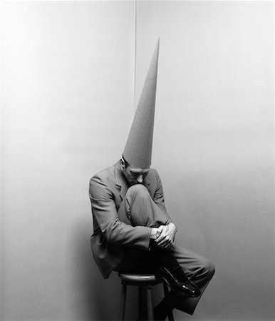 simsearch:700-00078438,k - Businessman Wearing Dunce Cap Sitting in Corner Stock Photo - Rights-Managed, Code: 700-00096750