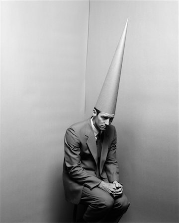 simsearch:700-00078438,k - Businessman Wearing Dunce Cap Sitting in Corner Stock Photo - Rights-Managed, Code: 700-00096751