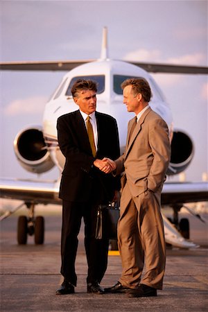 Businessmen Shaking Hands by Plane Stock Photo - Rights-Managed, Code: 700-00096840