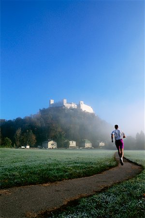 Woman Jogging by Salzburg Castle Austria Stock Photo - Rights-Managed, Code: 700-00091894