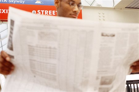 Businessman Reading Newspaper In Subway Stock Photo - Rights-Managed, Code: 700-00158107