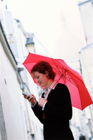 simsearch:700-00189516,k - Woman on Cell Phone with Umbrella Stock Photo - Rights-Managed, Code: 700-00151267