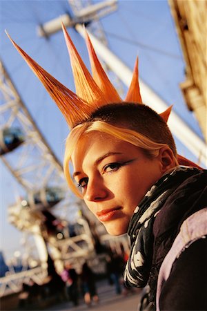 simsearch:700-00796323,k - Young Woman with Mohawk Hairstyle Standing Next to Ferris Wheel Stock Photo - Rights-Managed, Code: 700-00166376