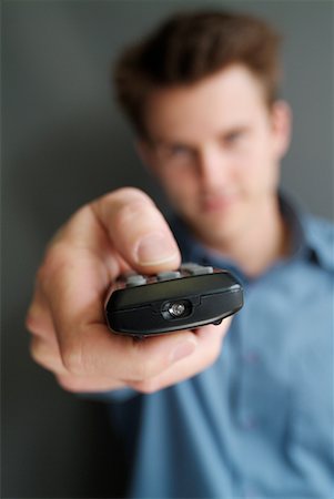 simsearch:700-00284729,k - Man Holding Remote Control Stock Photo - Rights-Managed, Code: 700-00178032