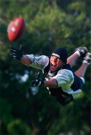 simsearch:854-03538943,k - Man Diving for Football Stock Photo - Rights-Managed, Code: 700-00185326