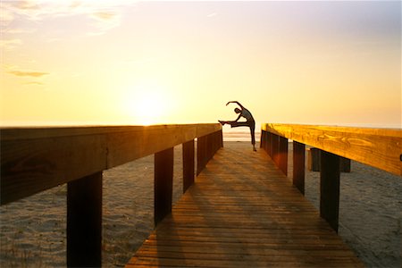simsearch:858-03052147,k - Woman Stretching on Beach Boardwalk Stock Photo - Rights-Managed, Code: 700-00185659